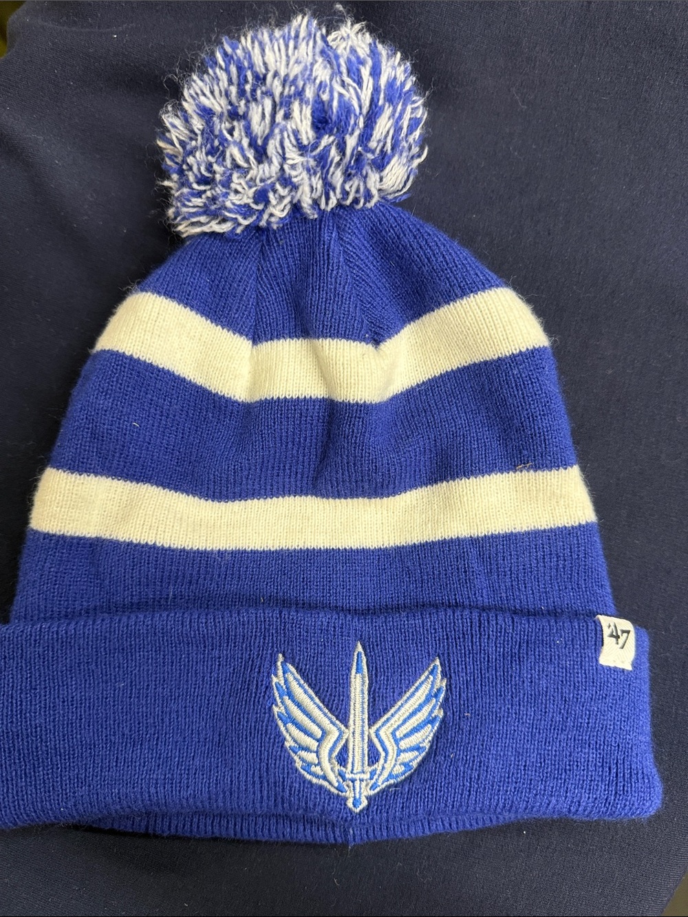 47 Kids Blue and Cream Striped Pom Beanie with Winged Sword Logo